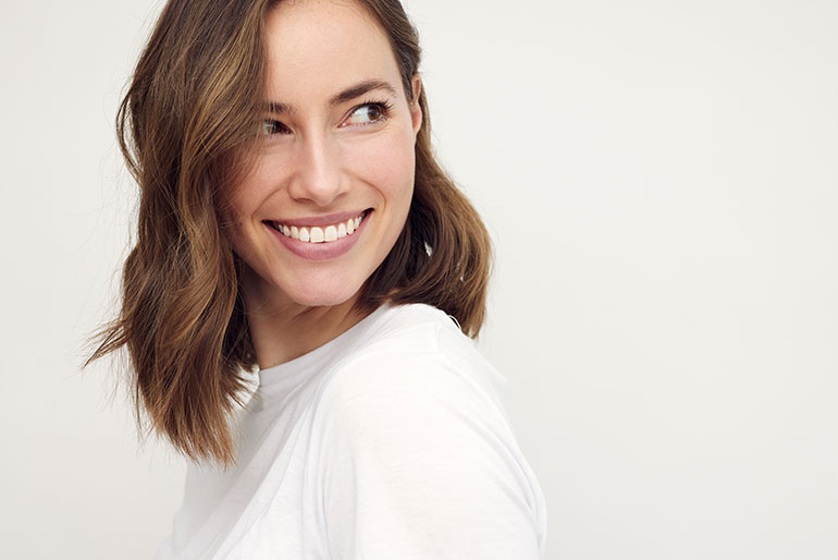 brunette-woman-smiling-and-looking-cute-to-the-right